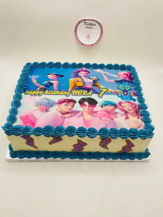 Blue sheet cake with a teal border and printed anime characters