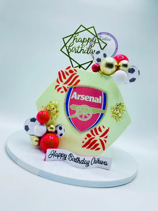 Hexagonal cake with an Arsenal FC crest print and edible soccer balls