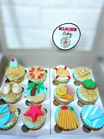 Beach themed cupcakes with fondant surfboards, flip-flops and starfish