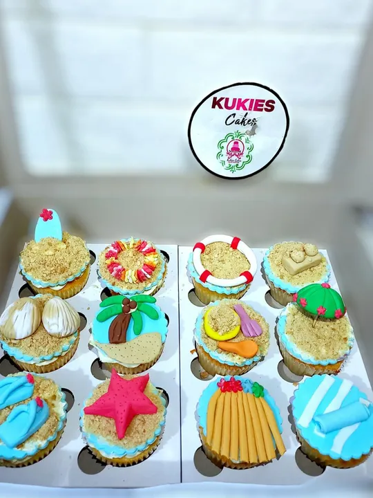 Beach themed cupcakes with fondant surfboards, flip-flops and starfish