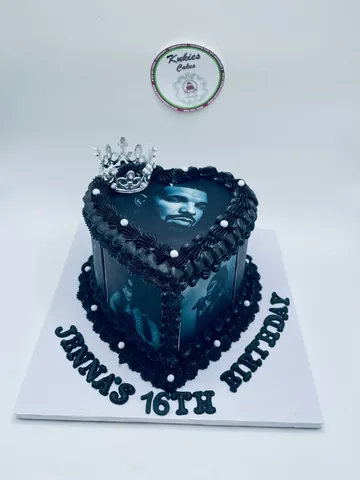 Black heart-shaped cake with a printed photo and silver crown for a 16th birthday