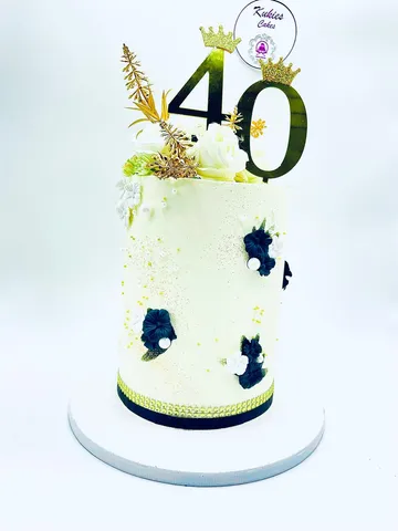 Cream cake with black and white fondant flowers and a gold 40 topper