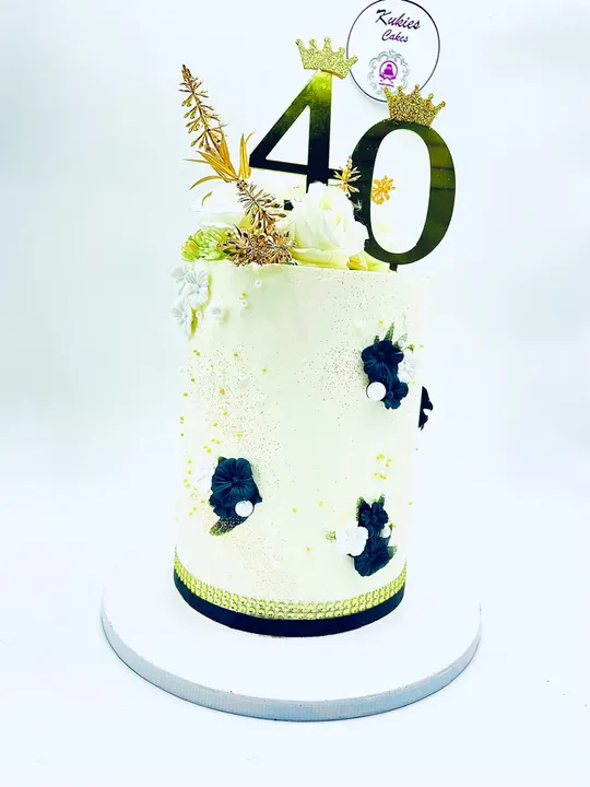 Cream cake with black and white fondant flowers and a gold 40 topper