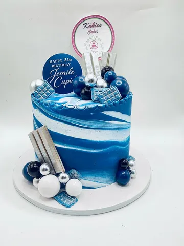 Blue and white marble cake with silver and blue spheres for a 21st birthday