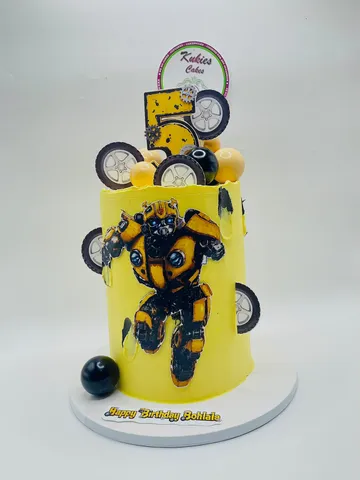 Yellow cake with a Transformers-style robot print, gears and a number 5 topper