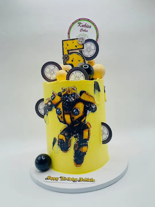 Yellow cake with a Transformers-style robot print, gears and a number 5 topper