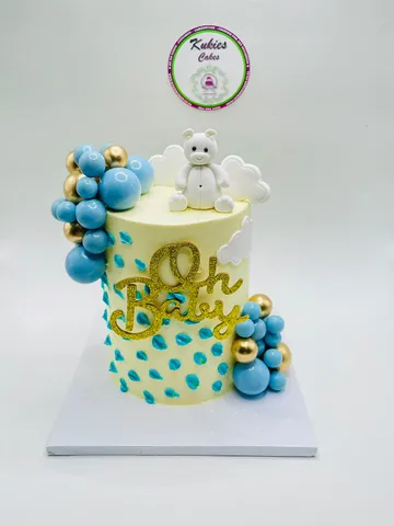 Cream Oh Baby cake with an angel teddy bear, clouds and blue raindrop piping