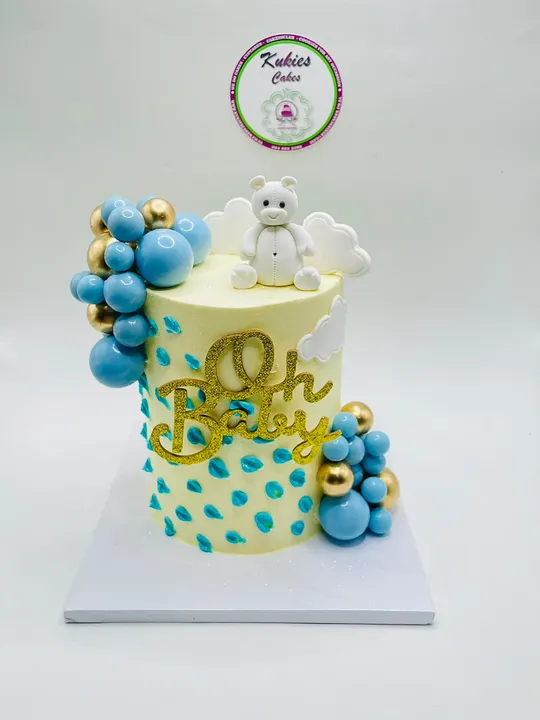 Cream Oh Baby cake with an angel teddy bear, clouds and blue raindrop piping