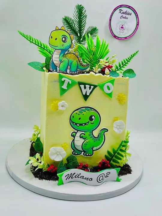 Yellow and green dinosaur themed cake with a TWO bunting
