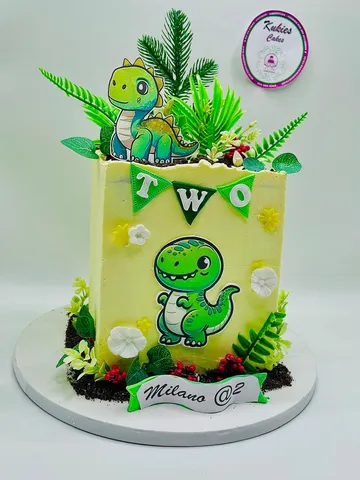 Yellow and green dinosaur themed cake with a TWO bunting
