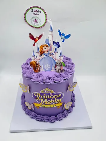 Purple Disney princess themed cake with a fondant castle topper