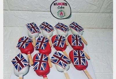 Red and white cakesicles with England flag toppers on sticks