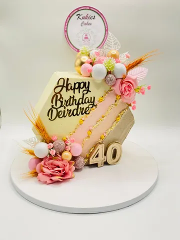 Hexagonal cake with a gold diagonal stripe and a gold 40 topper