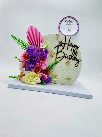 Textured plaque cake with a palm leaf pattern and purple and pink florals