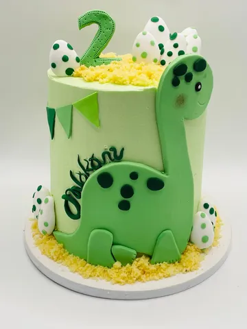Green cartoon dinosaur themed cake for a 2nd birthday