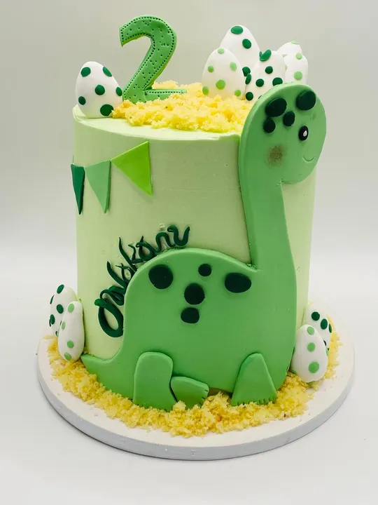 Green cartoon dinosaur themed cake for a 2nd birthday