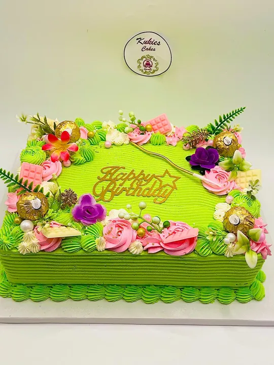Green rectangular sheet cake with pink roses and Ferrero Rocher chocolates