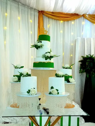 Green and white 4-tier wedding cake with matching minis and white roses