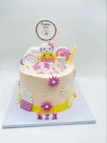 Hello Kitty themed birthday cake with a fondant ice cream cone and daisies