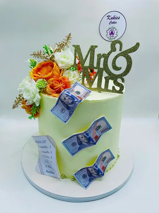 Pale green money themed wedding cake with a Mr and Mrs topper