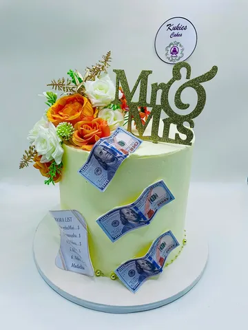 Pale green money themed wedding cake with a Mr and Mrs topper