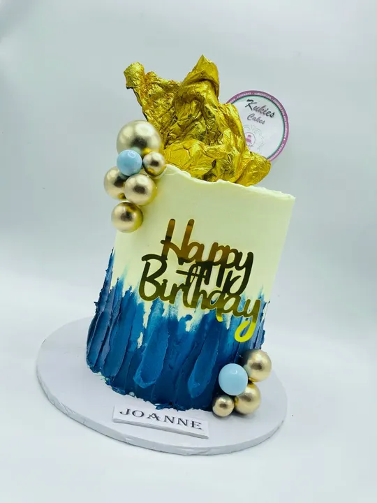 Cream and navy ombre cake with a crumpled gold foil topper