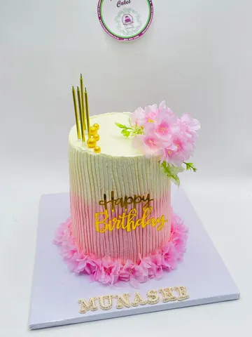 Pink and cream textured ombre cake with pink silk flowers and gold candles
