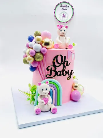 Pink baby shower cake with an Oh Baby topper, fondant teddy bears and a pastel balloon garland