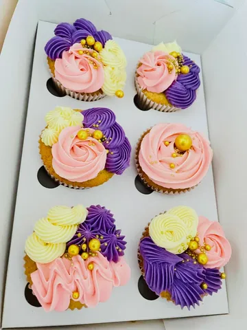 Cupcakes with pink and purple buttercream swirls and gold sugar pearls