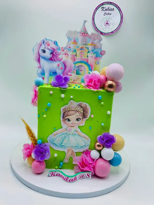 Green square cake with a fondant princess and unicorn castle topper