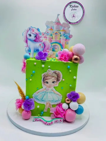 Green square cake with a fondant princess and unicorn castle topper