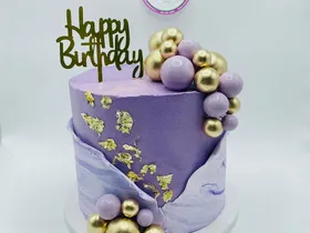 Purple marble ombre cake with gold leaf and lilac and gold spheres