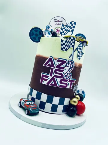 Mint and brown racing themed cake with toy race cars for a 2nd birthday