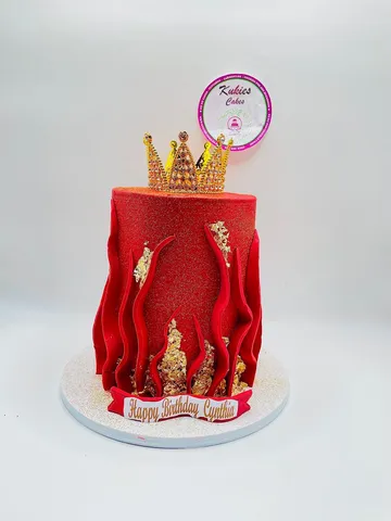 Red glitter cake with fondant flame spikes and a gold jewelled crown