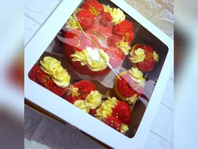 Red and gold bento cake with matching cupcakes finished in red and gold buttercream