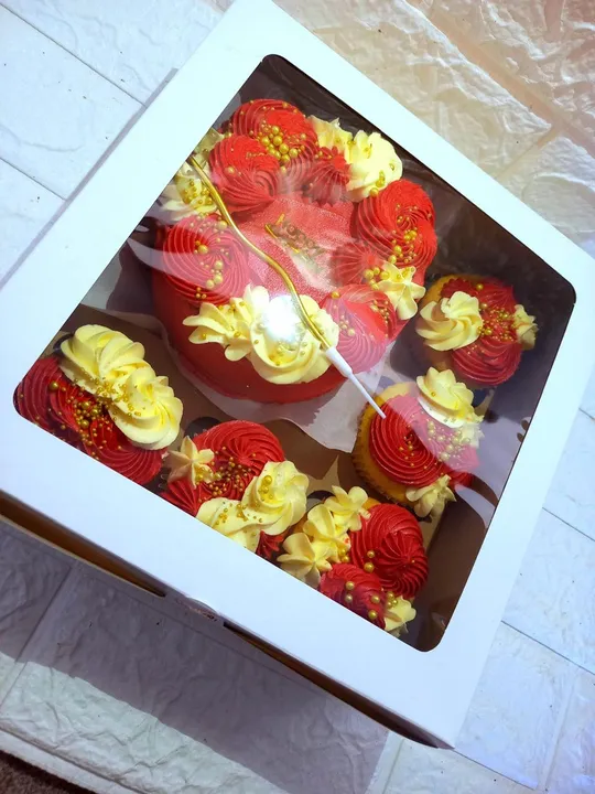 Red and gold bento cake with matching cupcakes finished in red and gold buttercream