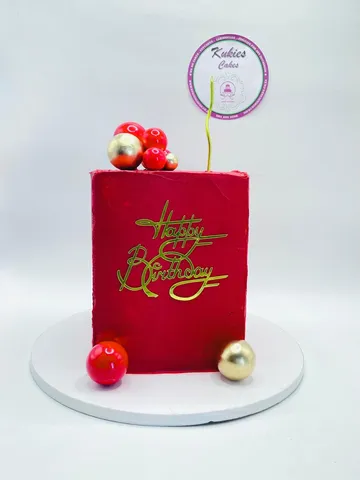 Red square cake with a gold and red sphere cluster