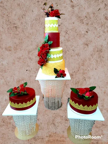Burgundy and gold 4-tier wedding cake with matching minis and red roses