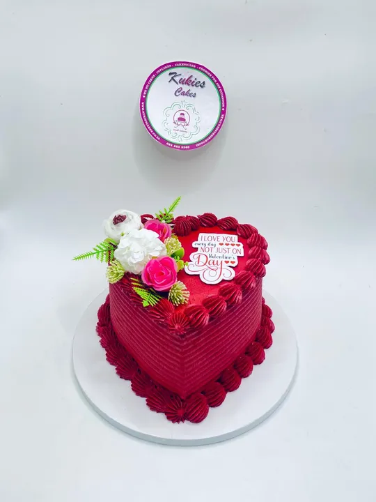 Red heart shaped Valentine's cake with white and pink florals