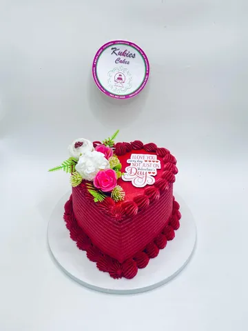 Red heart shaped Valentine's cake with white and pink florals