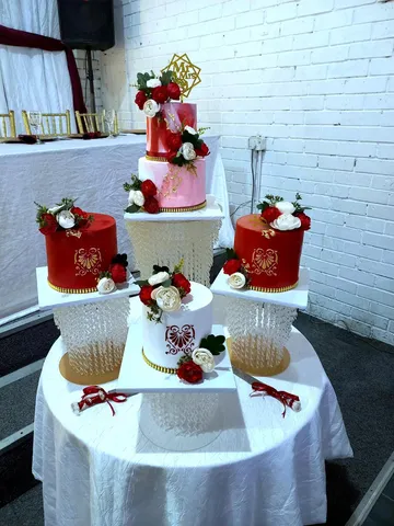 Two-tier pink and red marble wedding cake with matching red and white minis
