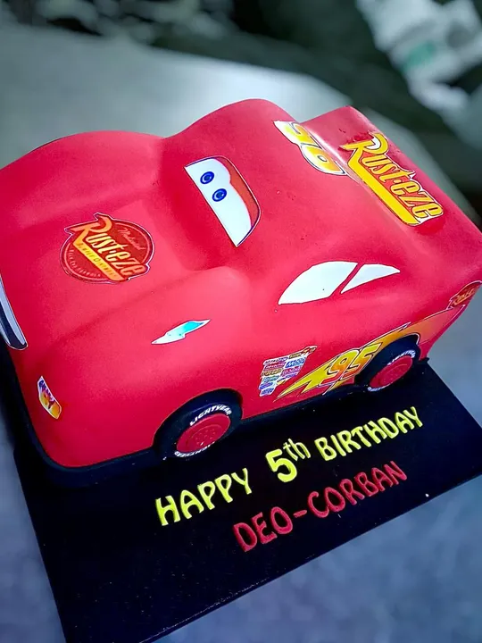 Red 3D race car shaped birthday cake
