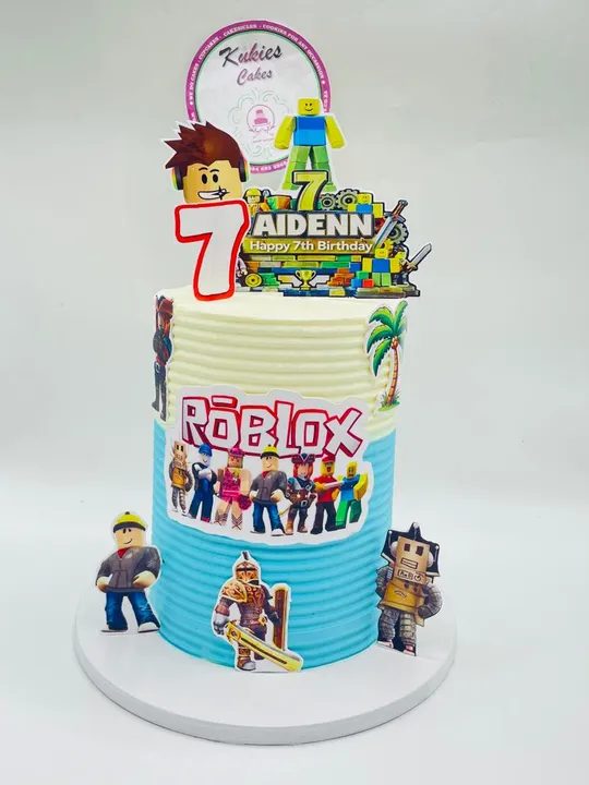 Yellow and teal Roblox themed two-tier birthday cake