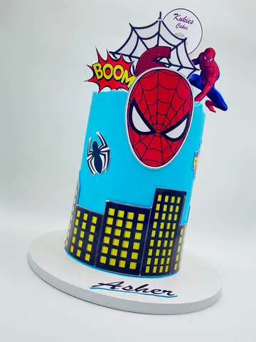 Blue Spider-Man themed birthday cake with a city skyline print