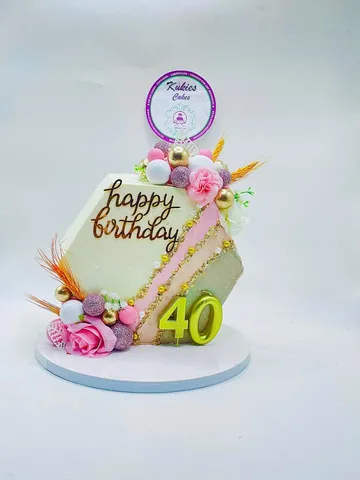 Hexagonal cake with wheat sprigs, pink roses and a lime 40 topper
