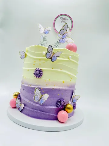 Yellow to purple ombre cake with edible butterflies and fondant flowers