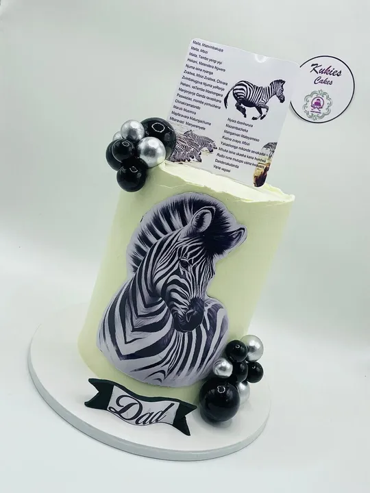 Pale green zebra print cake with black and silver spheres for a Dad celebration